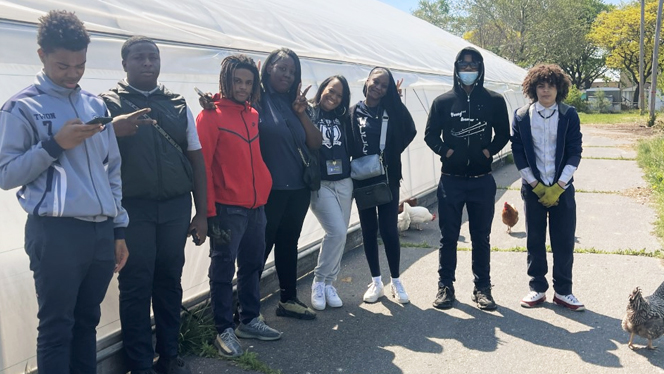 Group of students outside greenhouse.