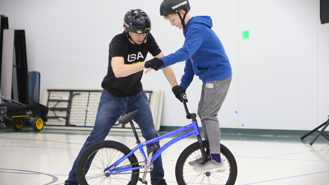 Wilhelm with student on bike
