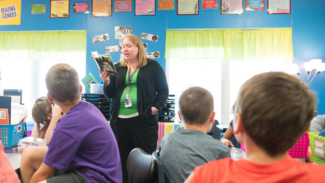 A teacher reading to students. A teacher reading to students.