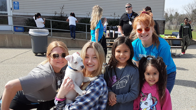 People holding a puppy. People holding a puppy.