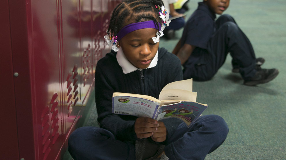 Girl reading in hallway