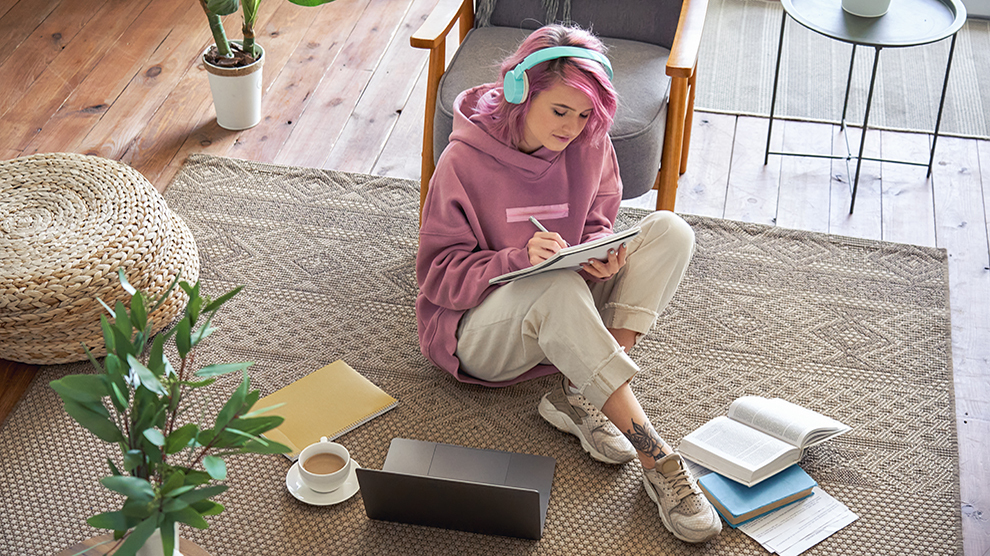 Girl doing homework on the floor