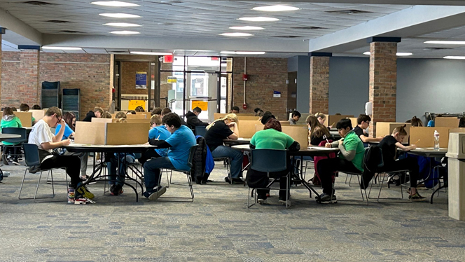 Competitors working at their tables. Competitors working at their tables.