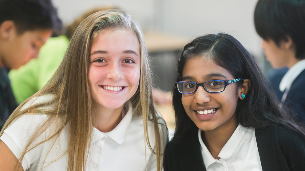 Two students smiling