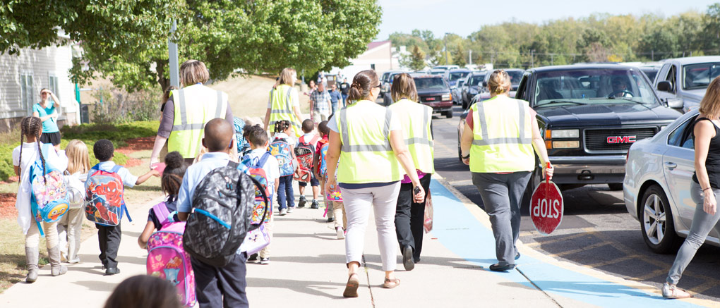 Teachers assisting arriving students