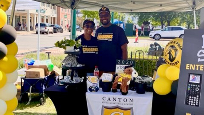 Couple standing at a Canton information table. Couple standing at a Canton information table.
