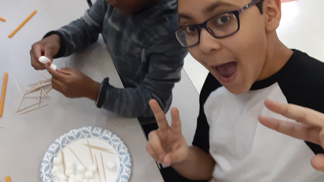Student posing with marshmallows and toothpicks. Student posing with marshmallows and toothpicks.