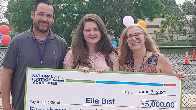 Ella Bist holding a large $5,000 check