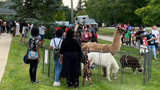 People at a petting zoo. People at a petting zoo.