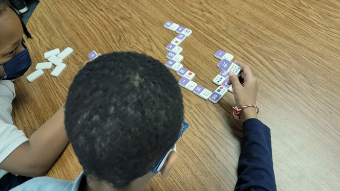 Students playing dominos. Students playing dominos.