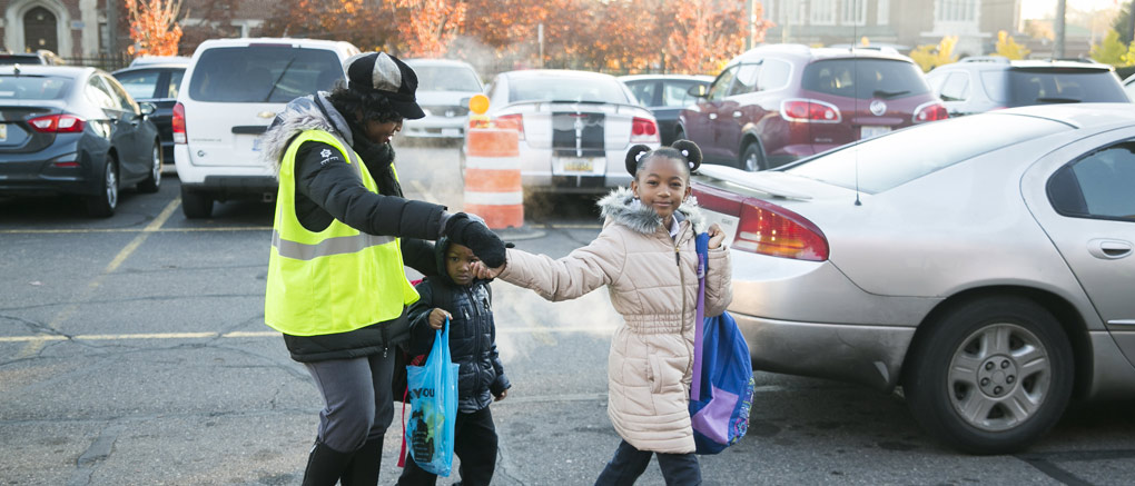 Helping students cross parking lot