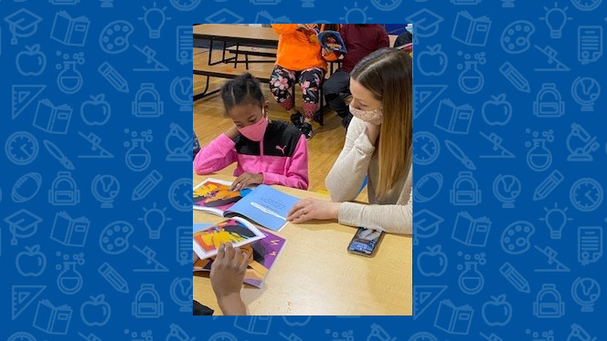 teacher reading with a student