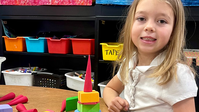 Student with tower she built