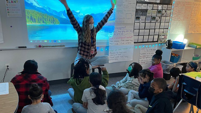 Teacher leading students in controlled breathing. Teacher leading students in controlled breathing.