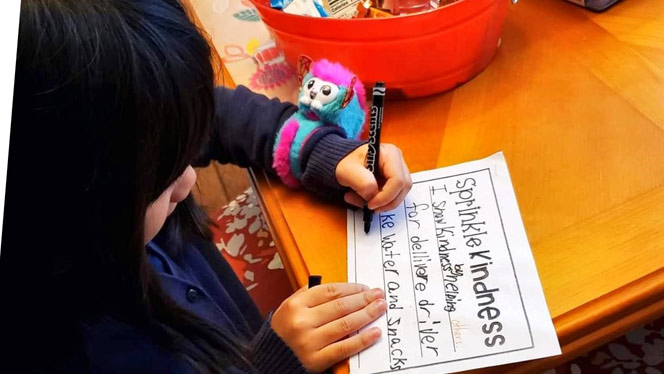 Child at a table writing
