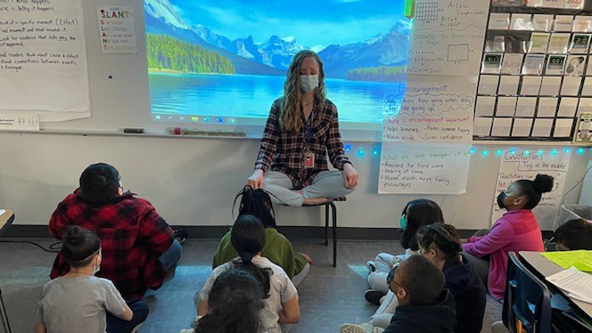Teacher leading students in breathing exercises. Teacher leading students in breathing exercises.