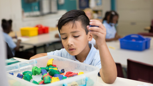 Student using math cubes