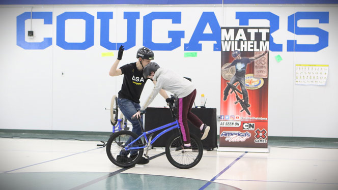 Wilhelm with student on bike