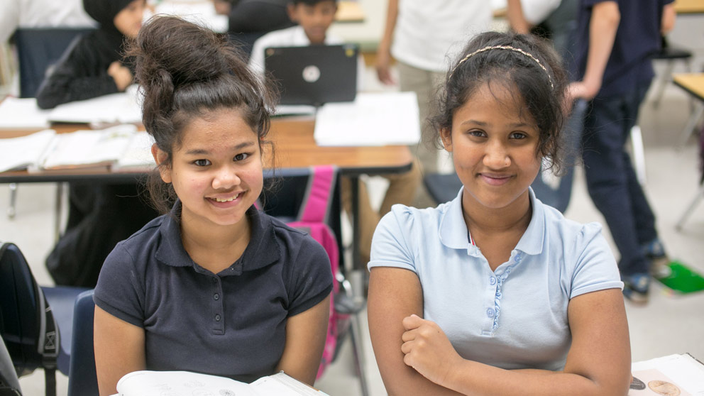 Two students smiling