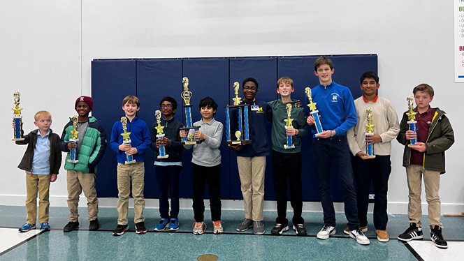 Students pose with trophies